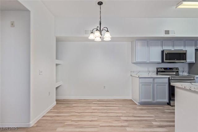 kitchen featuring gray cabinets, appliances with stainless steel finishes, decorative light fixtures, light stone counters, and light hardwood / wood-style flooring