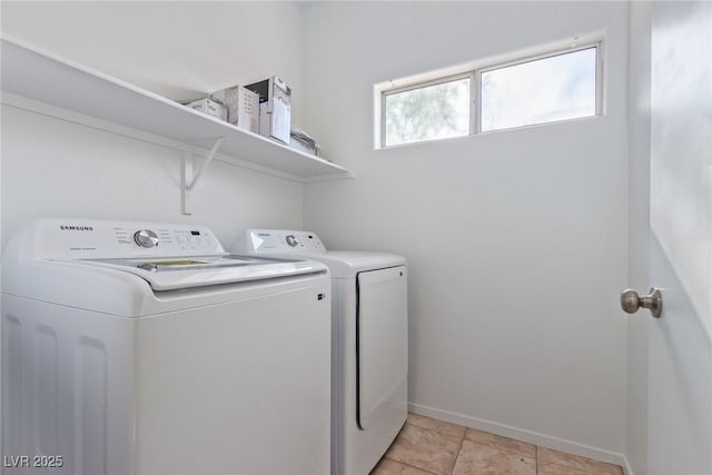 clothes washing area featuring separate washer and dryer and light tile patterned floors