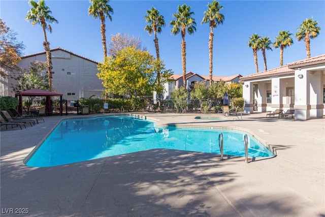 view of pool with a hot tub, a gazebo, and a patio