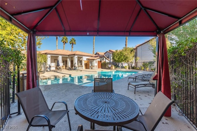 view of patio with a fenced in pool and a gazebo