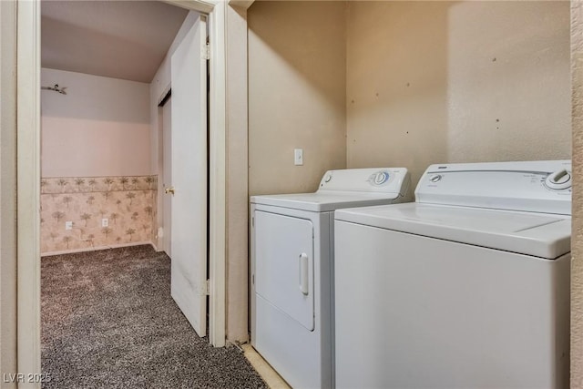 clothes washing area featuring separate washer and dryer and carpet