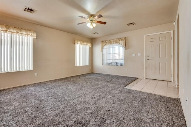 unfurnished room featuring light carpet and ceiling fan