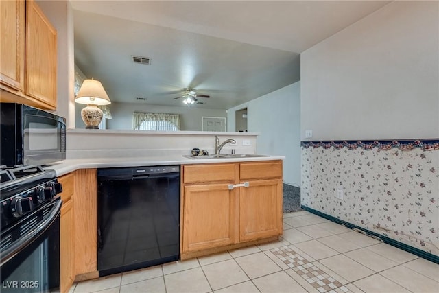 kitchen with sink, light tile patterned floors, ceiling fan, black appliances, and decorative light fixtures