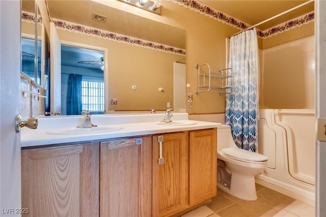 full bathroom featuring vanity, tile patterned flooring, toilet, and shower / tub combo with curtain