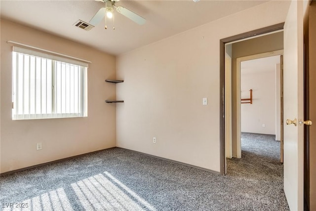 carpeted spare room with ceiling fan