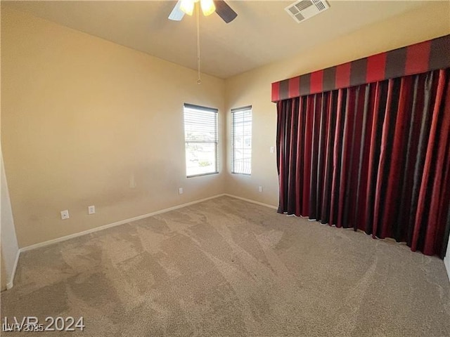 spare room featuring carpet floors and ceiling fan