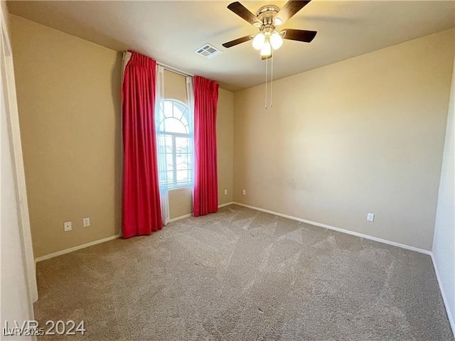 unfurnished room featuring baseboards, carpet floors, visible vents, and a ceiling fan
