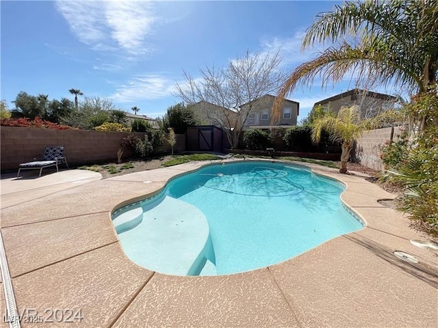 view of pool featuring a fenced backyard, a fenced in pool, and a patio