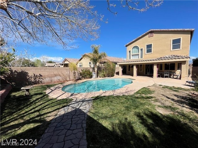 view of pool with a fenced backyard, a fenced in pool, a yard, and a patio