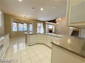 kitchen with visible vents, dishwasher, a sink, an inviting chandelier, and light tile patterned floors