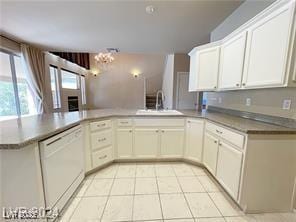 kitchen with white cabinetry, light tile patterned floors, a sink, dishwasher, and a notable chandelier