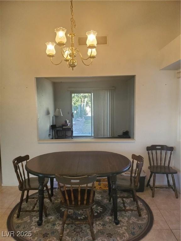 dining space with an inviting chandelier and light tile patterned floors