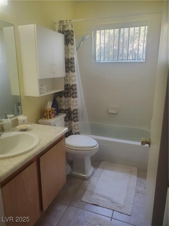 full bathroom with shower / bathtub combination with curtain, vanity, tile patterned flooring, and toilet