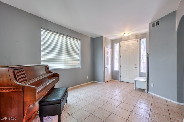 tiled foyer featuring plenty of natural light