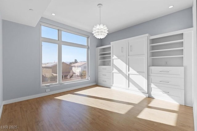 interior space with hardwood / wood-style floors and a chandelier