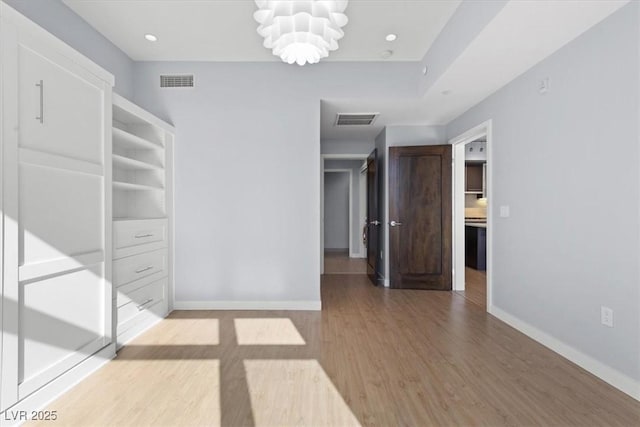 interior space with a notable chandelier and light hardwood / wood-style floors