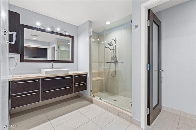 bathroom featuring vanity, tile patterned floors, and a shower with shower door