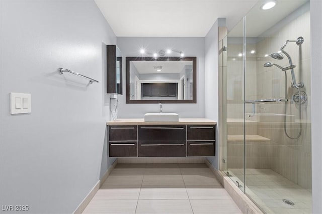 bathroom with vanity, an enclosed shower, and tile patterned flooring