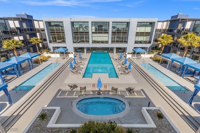 view of pool featuring a patio area and a community hot tub