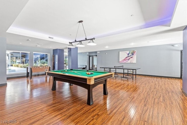 rec room featuring hardwood / wood-style floors, pool table, and a tray ceiling