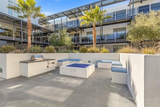 view of patio / terrace with an outdoor kitchen and an outdoor fire pit