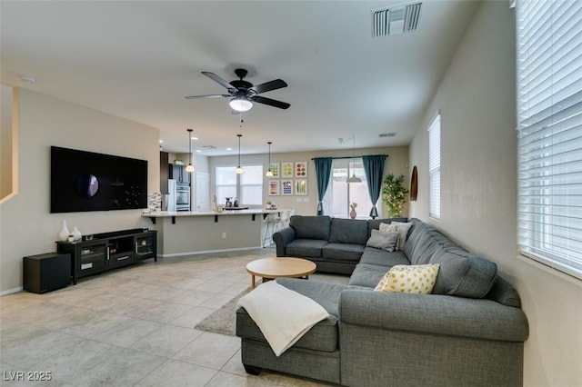 tiled living room featuring ceiling fan