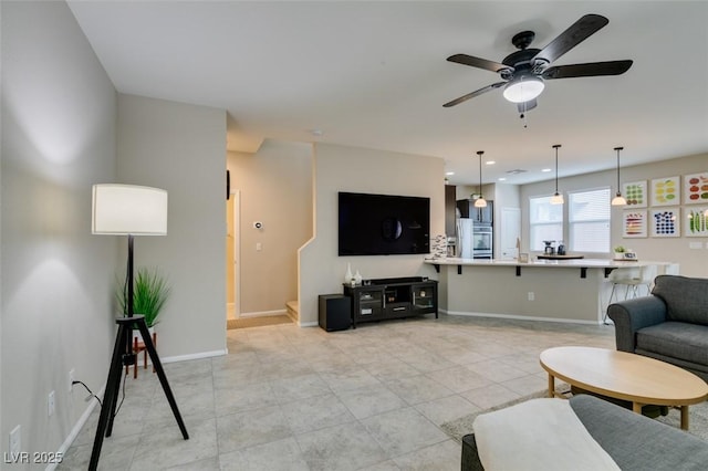 tiled living room with ceiling fan