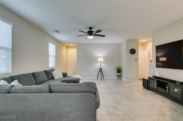 living room with ceiling fan and light tile patterned flooring