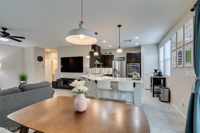 tiled dining room with sink and ceiling fan