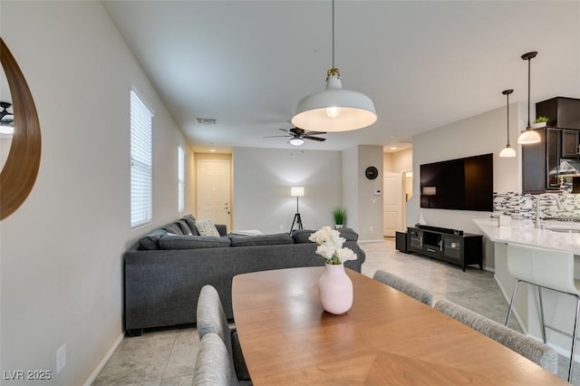 dining room featuring sink and ceiling fan