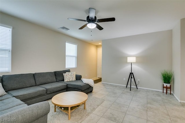 tiled living room featuring ceiling fan