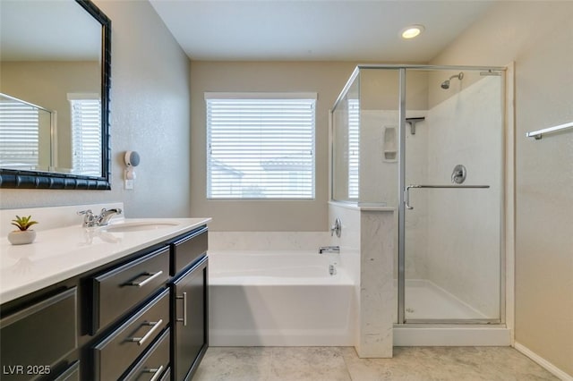 bathroom with vanity, tile patterned floors, and plus walk in shower