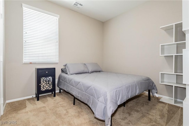 bedroom featuring light colored carpet, visible vents, and baseboards