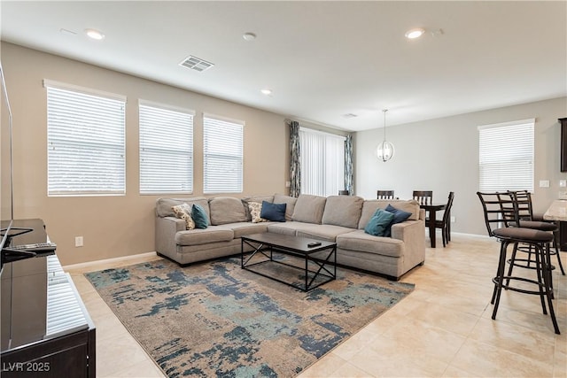 living room featuring light tile patterned floors, baseboards, visible vents, and recessed lighting