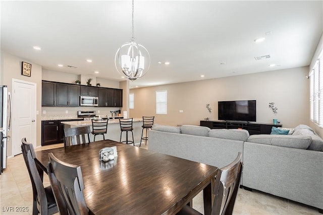 dining space with a chandelier, light tile patterned floors, visible vents, and recessed lighting