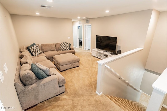 living area featuring light carpet, visible vents, and recessed lighting