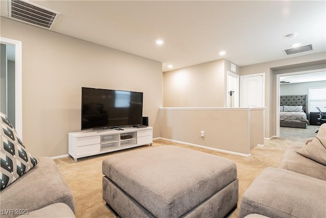 living area featuring light carpet, recessed lighting, visible vents, and baseboards