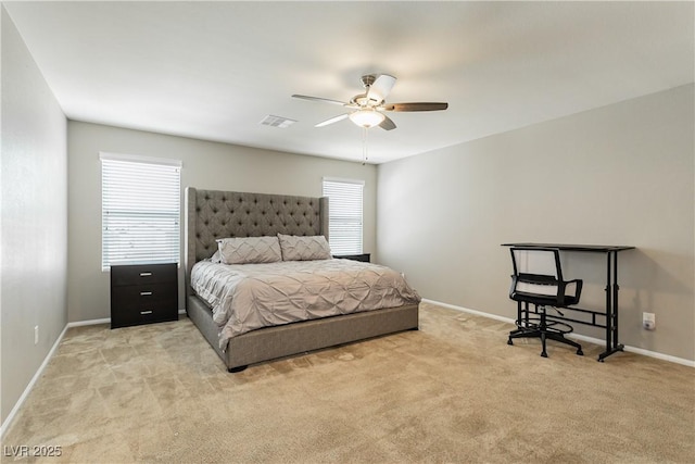 bedroom featuring a ceiling fan, light carpet, visible vents, and baseboards