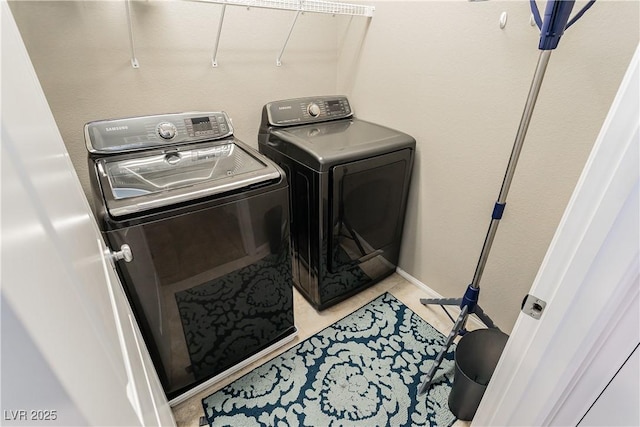 clothes washing area featuring washer and dryer and laundry area