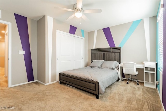 bedroom with a ceiling fan, baseboards, a closet, and light colored carpet