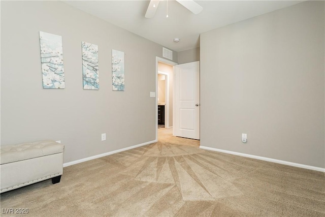 sitting room featuring baseboards, a ceiling fan, visible vents, and light colored carpet