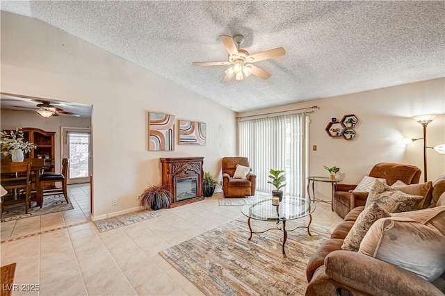 tiled living room with ceiling fan, lofted ceiling, and a textured ceiling