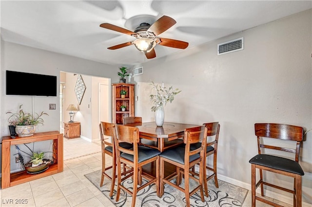 tiled dining area featuring ceiling fan