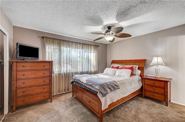 carpeted bedroom with a textured ceiling and ceiling fan