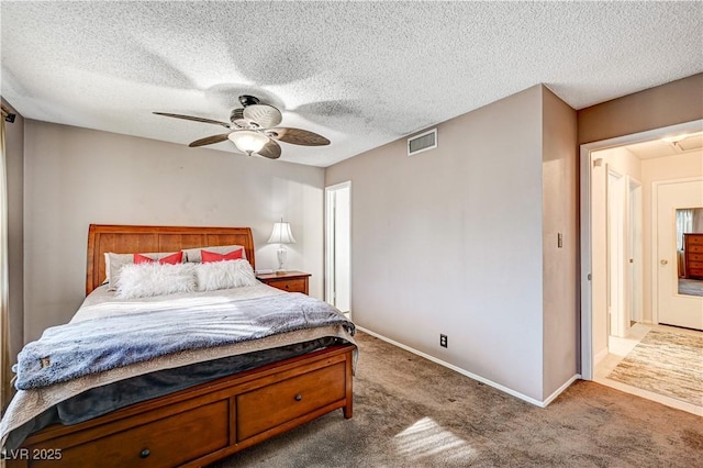 carpeted bedroom with a textured ceiling and ceiling fan