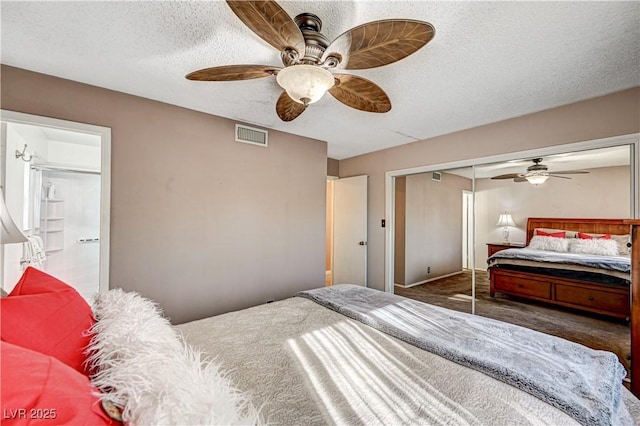 bedroom featuring ceiling fan, a closet, a textured ceiling, and ensuite bathroom