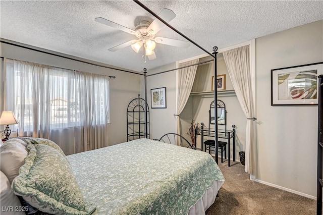 carpeted bedroom with ceiling fan and a textured ceiling