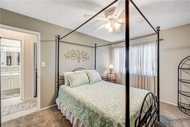 bedroom featuring ceiling fan, carpet floors, sink, and a textured ceiling