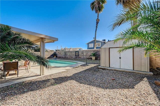 view of swimming pool with a shed