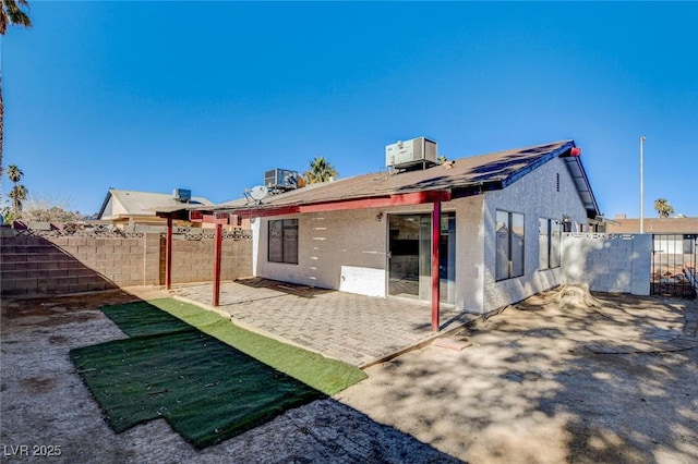 back of property featuring cooling unit and a patio area